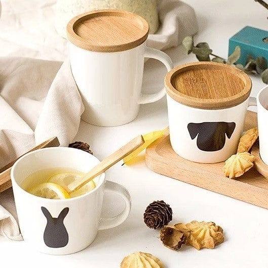 https://www.modernquests.com/cdn/shop/files/philosophy-home-porcelain-short-cup-with-decal-and-lid-dog-2_600x.jpg?v=1690037152